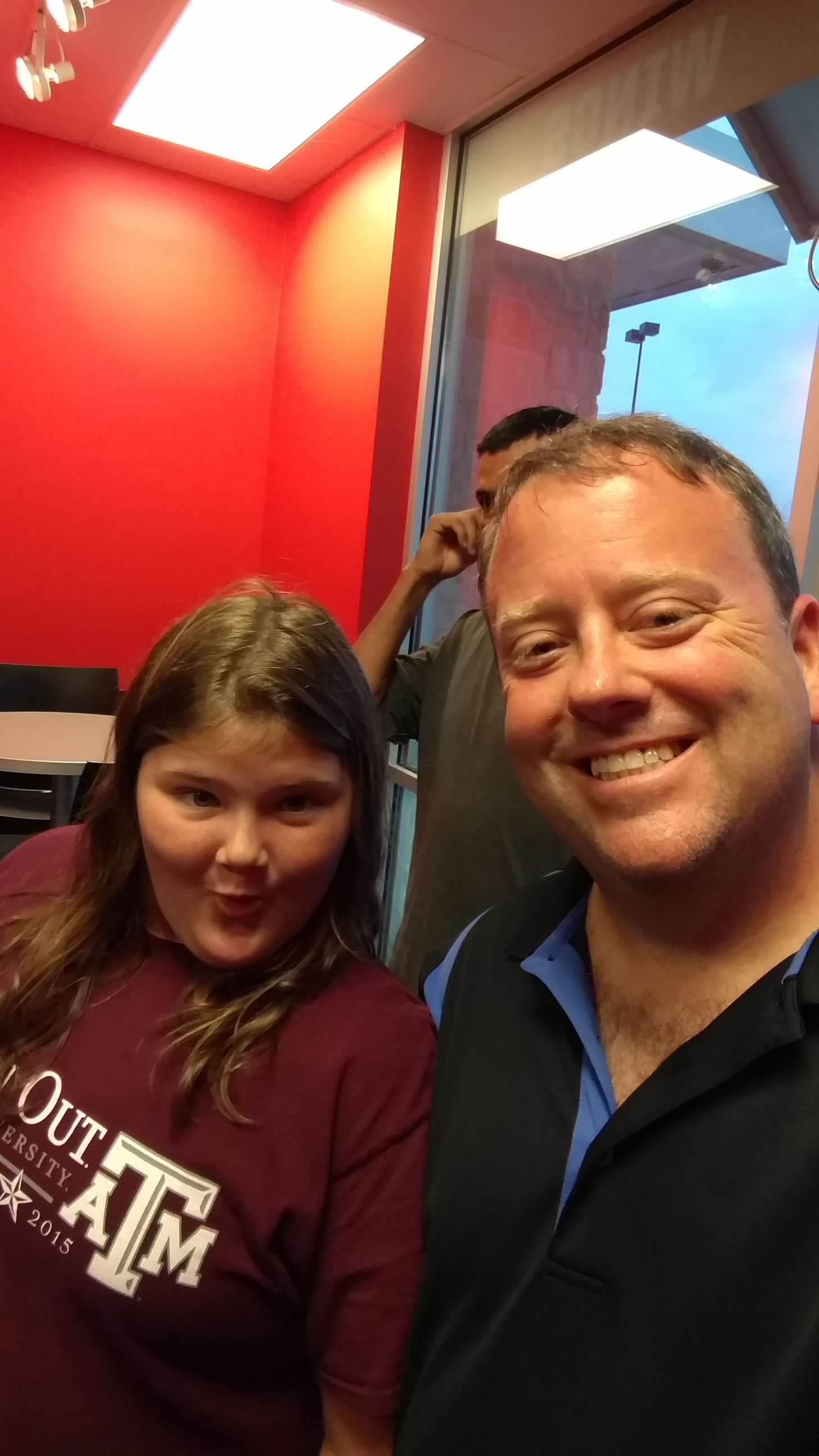 Bailey Schmitt with a family member, both wearing Texas A&M shirts